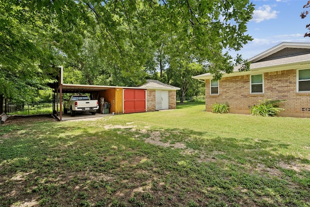 view of yard with a carport and an outbuilding