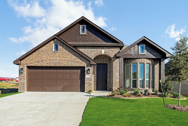 craftsman inspired home featuring a front lawn and a garage