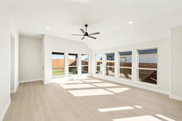 unfurnished living room featuring vaulted ceiling, light hardwood / wood-style flooring, and ceiling fan