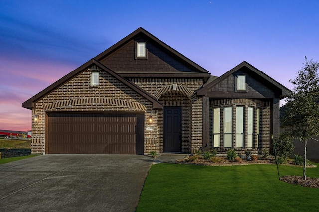 view of front facade with a lawn and a garage