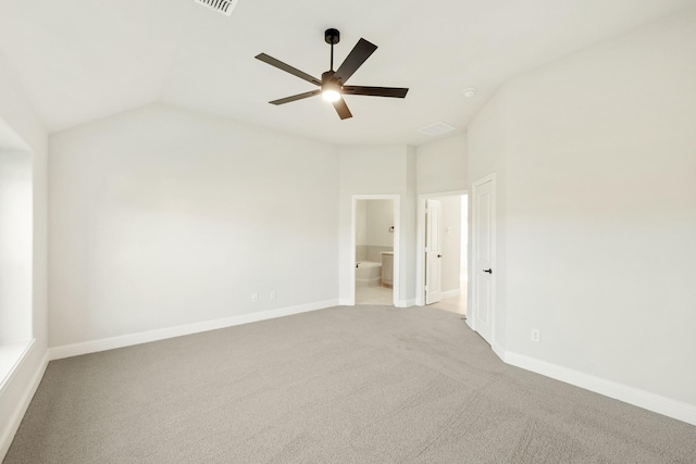 unfurnished bedroom with ceiling fan, ensuite bathroom, lofted ceiling, and light carpet