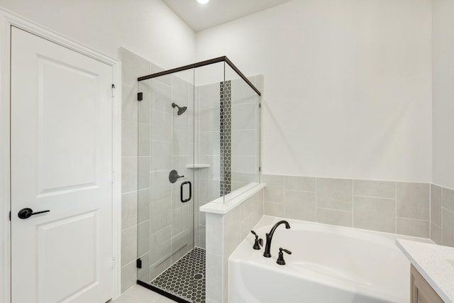 bathroom featuring tile patterned floors, vanity, and independent shower and bath