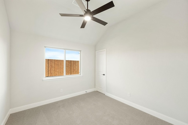 carpeted empty room featuring ceiling fan and lofted ceiling