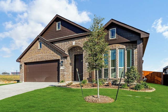 view of front of house featuring a garage and a front lawn