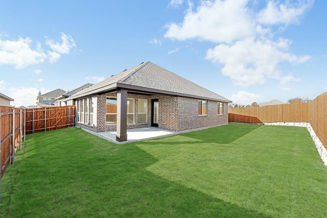 rear view of house featuring a patio and a lawn