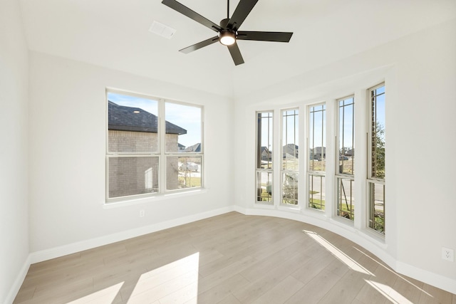 unfurnished sunroom featuring ceiling fan