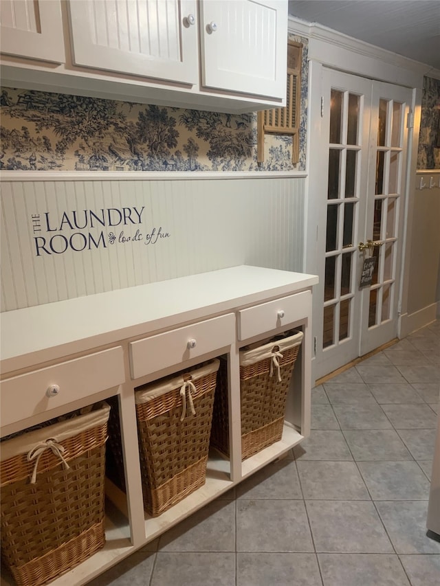 mudroom with light tile patterned flooring and ornamental molding