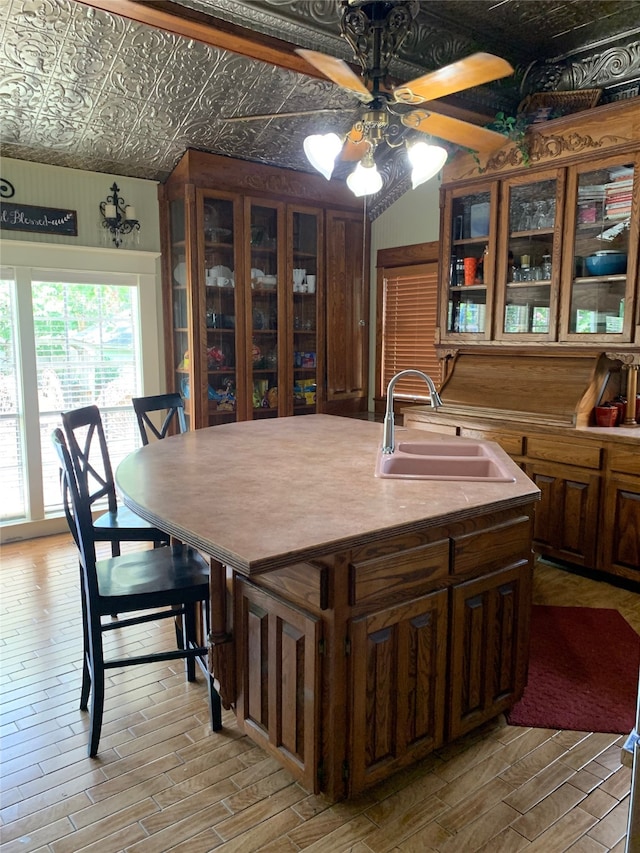 dining room with ceiling fan, sink, and light hardwood / wood-style floors