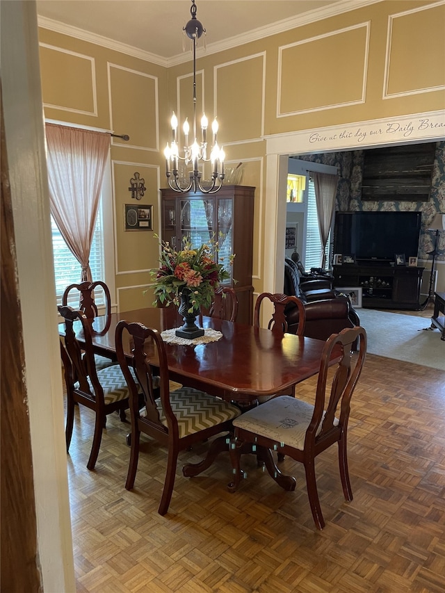 dining area featuring a stone fireplace, parquet floors, an inviting chandelier, and crown molding