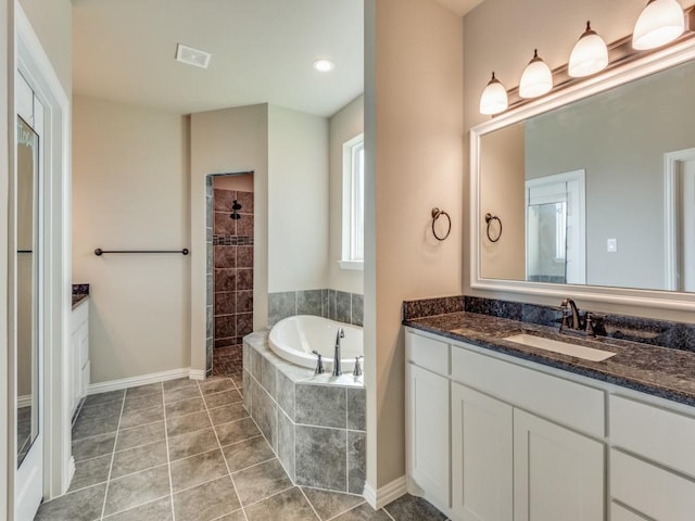 bathroom featuring tile patterned floors, vanity, and separate shower and tub