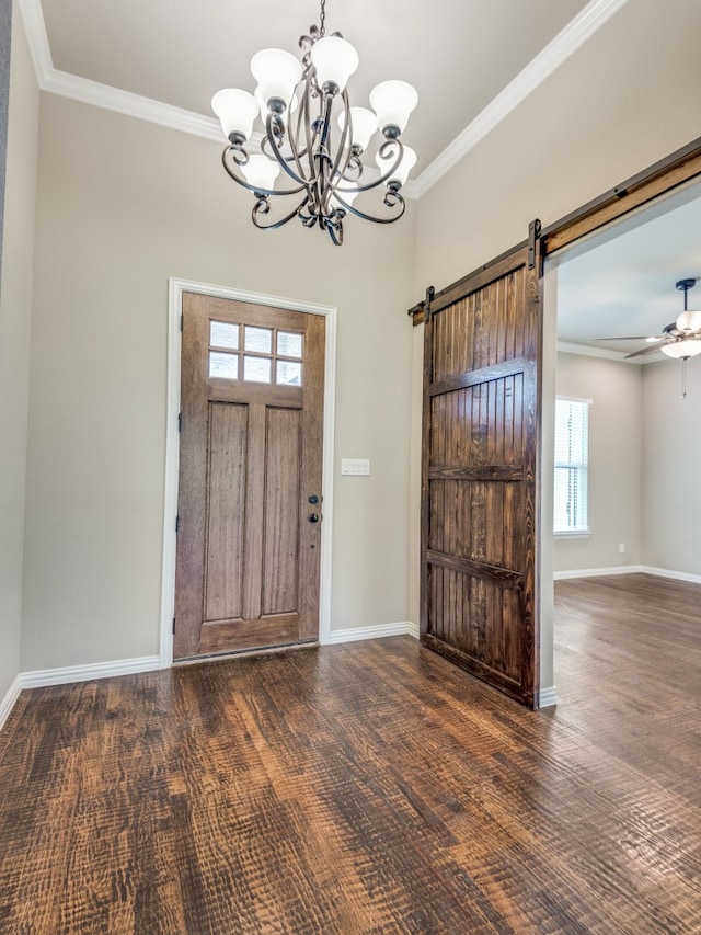 foyer with ornamental molding, a barn door, a chandelier, and dark wood-type flooring