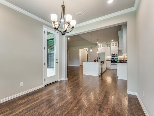 interior space with ornamental molding, sink, and a notable chandelier