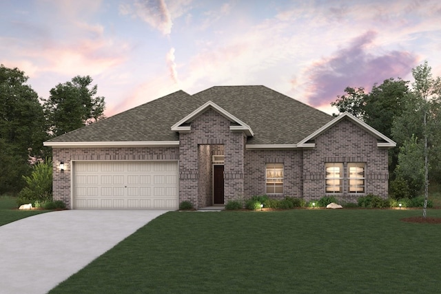 view of front of property featuring a yard and a garage