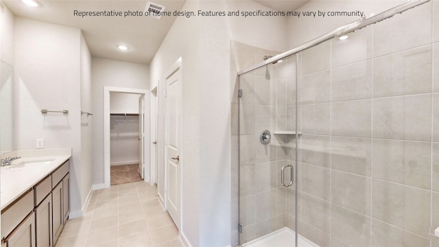 bathroom featuring vanity, tile patterned floors, and walk in shower