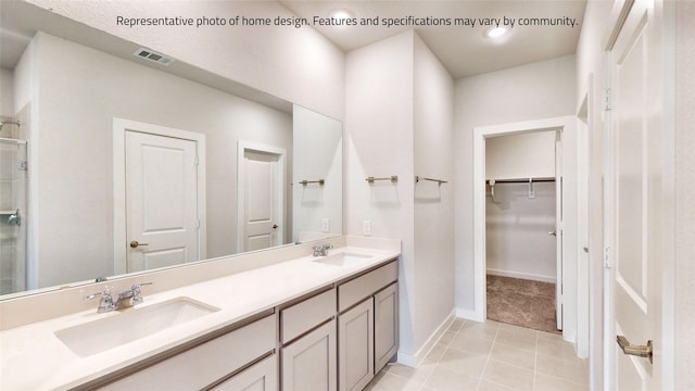 bathroom featuring vanity, a shower with shower door, and tile patterned floors