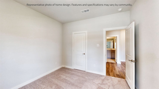 unfurnished bedroom with light carpet