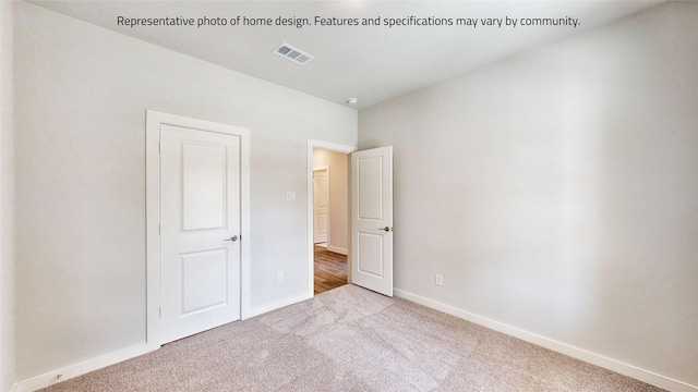 unfurnished bedroom with light colored carpet