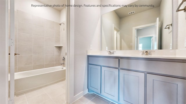 bathroom with vanity, tile patterned flooring, and tiled shower / bath