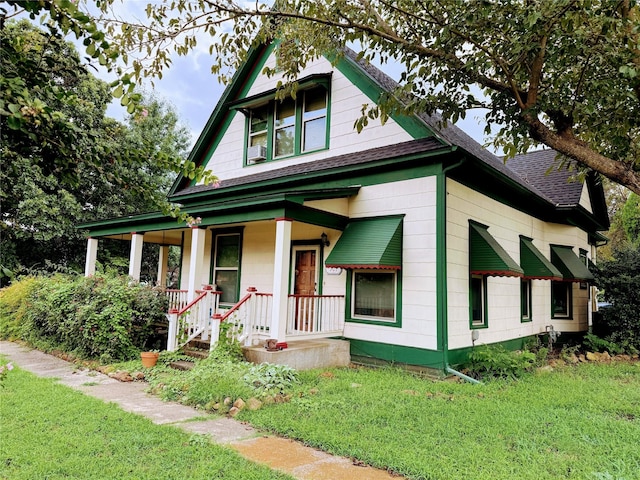 view of front of property with a porch and a front lawn