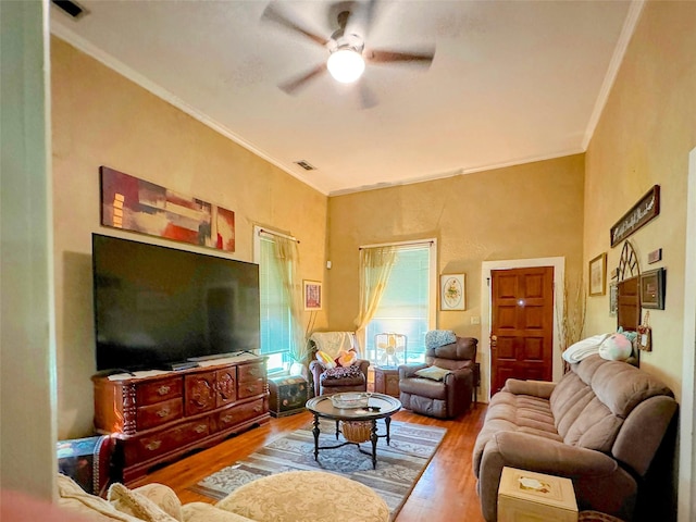 living room with wood-type flooring, ceiling fan, and crown molding