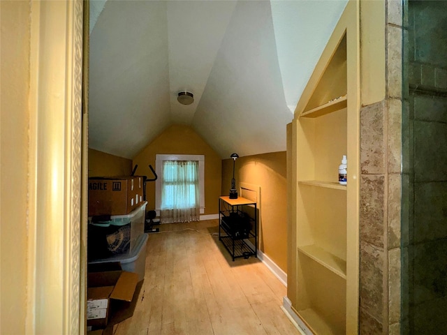 bonus room with lofted ceiling and wood-type flooring