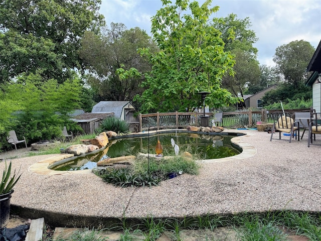 surrounding community featuring a swimming pool and a patio area