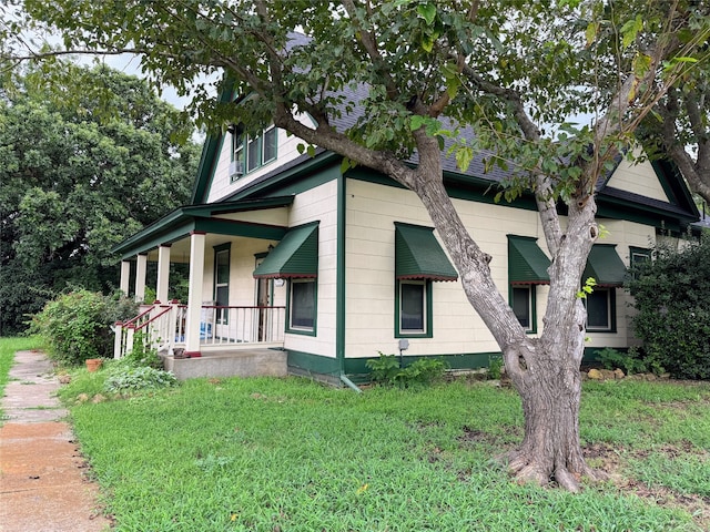 exterior space with a porch and a lawn