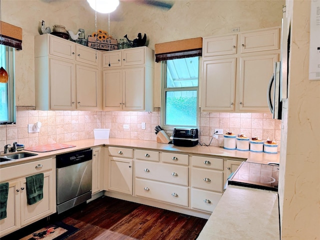 kitchen featuring sink, stainless steel dishwasher, dark hardwood / wood-style flooring, decorative backsplash, and stove