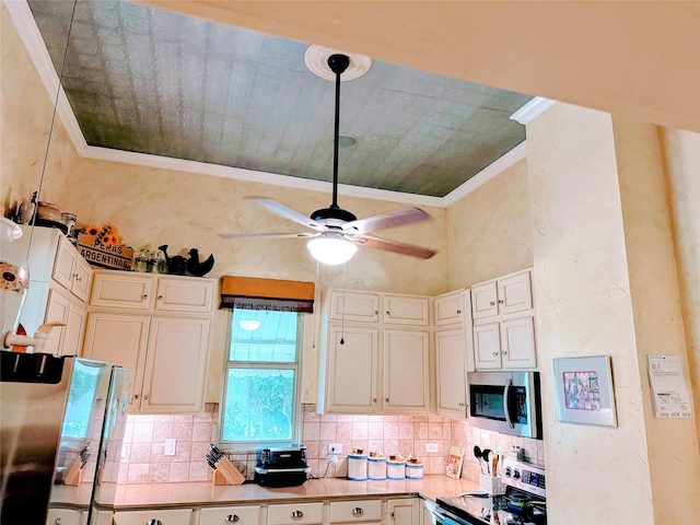 kitchen with crown molding, appliances with stainless steel finishes, ceiling fan, and decorative backsplash