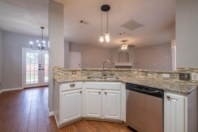 kitchen with white cabinetry, dishwasher, a peninsula, and a sink