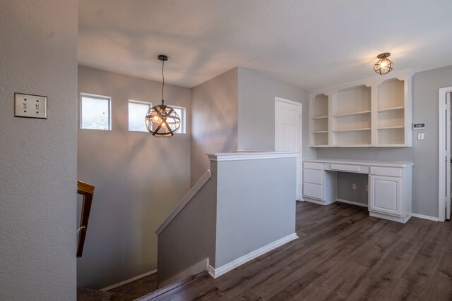 interior space with dark hardwood / wood-style flooring and built in desk