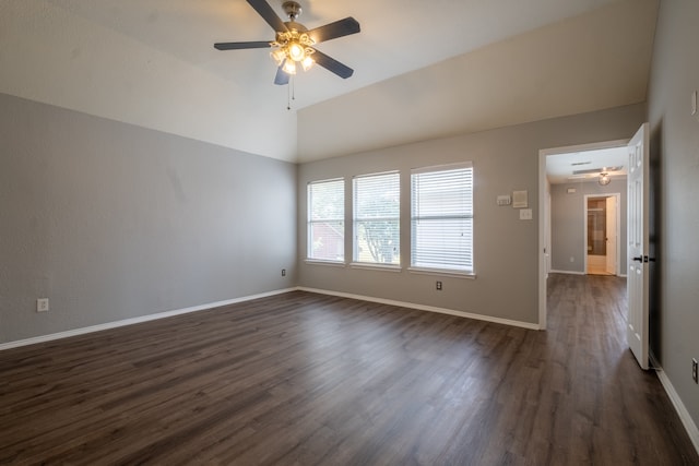 empty room with lofted ceiling, ceiling fan, and dark hardwood / wood-style floors