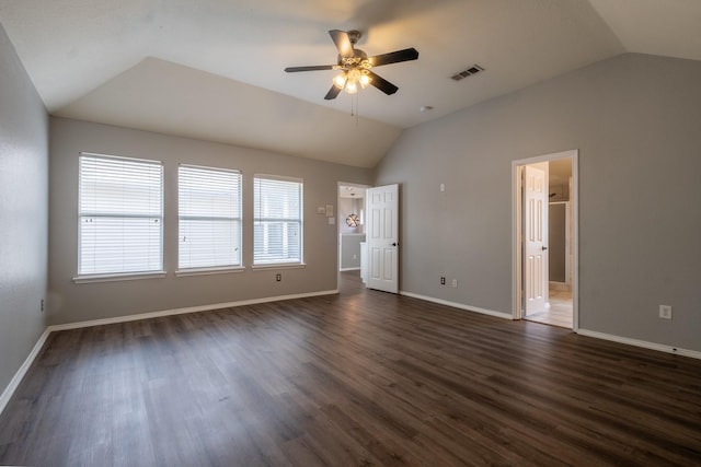 unfurnished bedroom with dark wood-type flooring, a ceiling fan, visible vents, vaulted ceiling, and baseboards