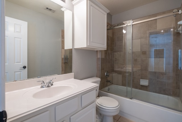 full bathroom featuring vanity, toilet, tile patterned flooring, and enclosed tub / shower combo