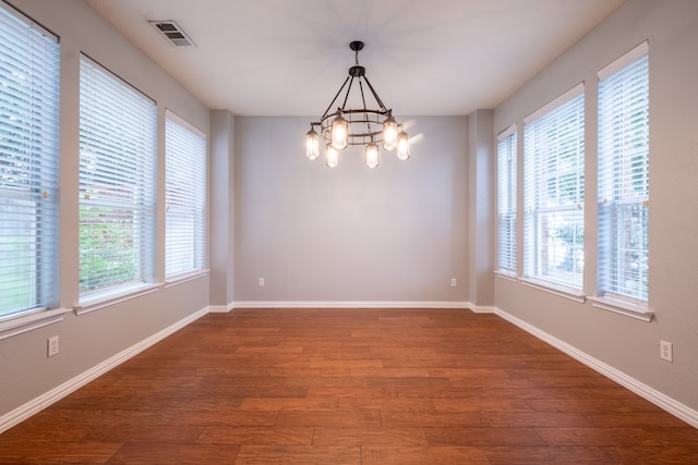 spare room with hardwood / wood-style flooring and plenty of natural light