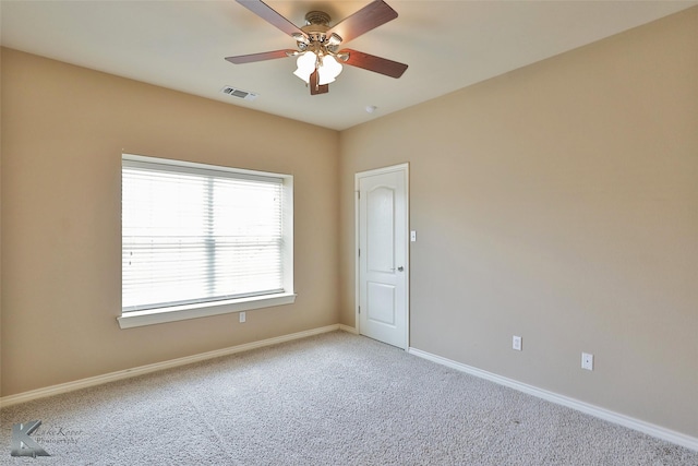 spare room featuring ceiling fan and carpet flooring