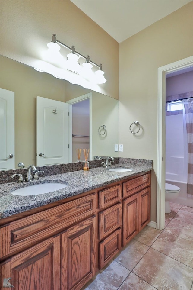 full bathroom featuring toilet, vanity, tile patterned flooring, and shower / tub combo