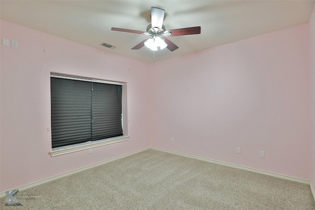 spare room featuring ceiling fan and carpet floors