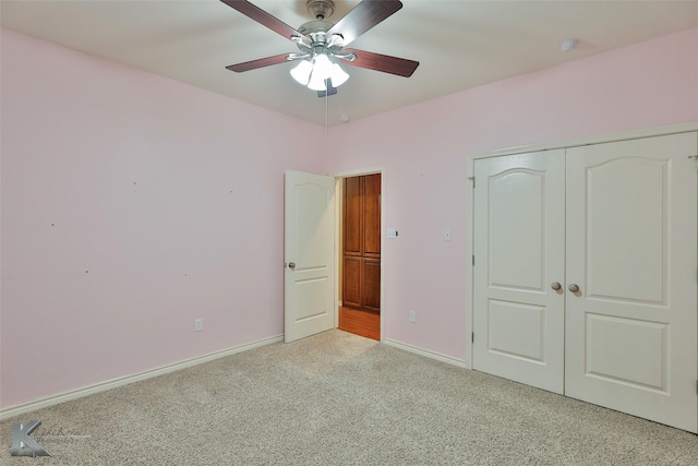 unfurnished bedroom featuring light carpet, ceiling fan, and a closet