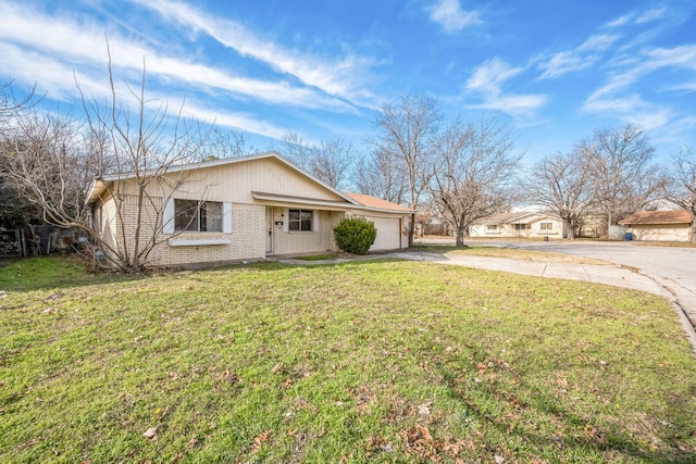 view of front of property with a front yard and a garage