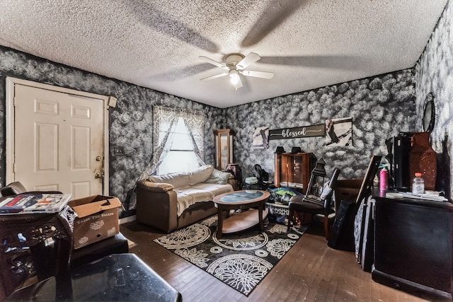 living room with wood-type flooring, a textured ceiling, and ceiling fan