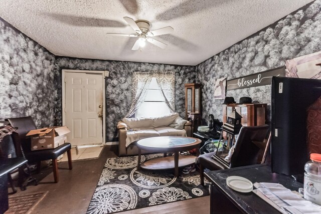 sitting room featuring a textured ceiling and ceiling fan