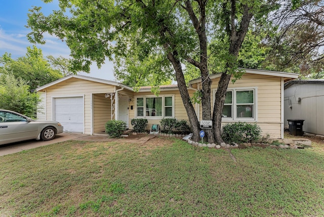 ranch-style house with a garage and a front lawn