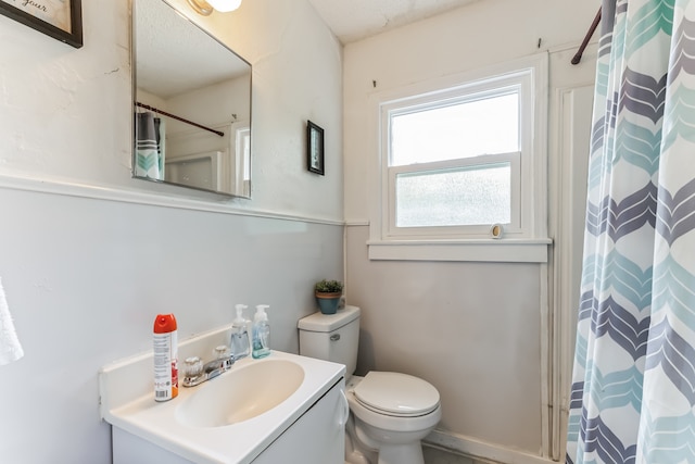 bathroom featuring toilet and vanity