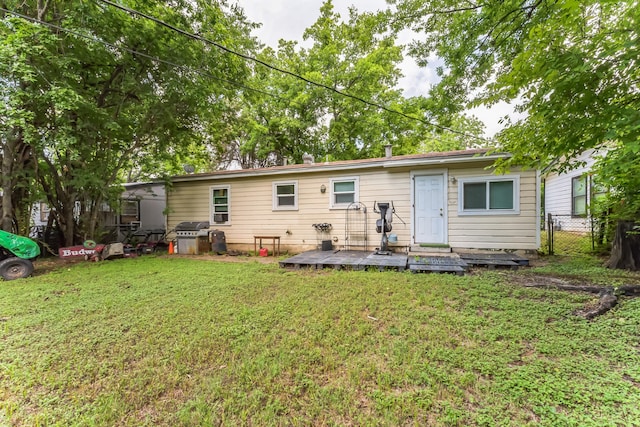 back of house with a lawn