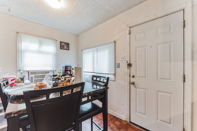 dining room with a textured ceiling, cooling unit, and parquet floors