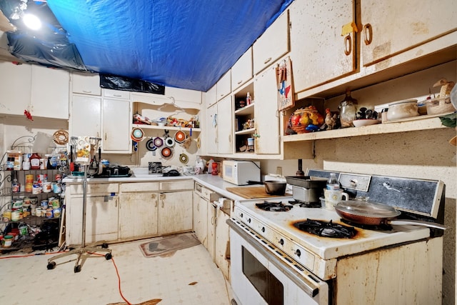 kitchen with white cabinets, white range with gas stovetop, and light tile patterned floors