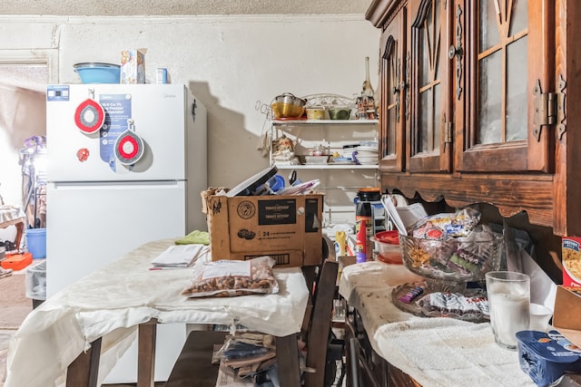 kitchen with white fridge and crown molding