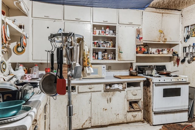 kitchen featuring white cabinetry and white appliances