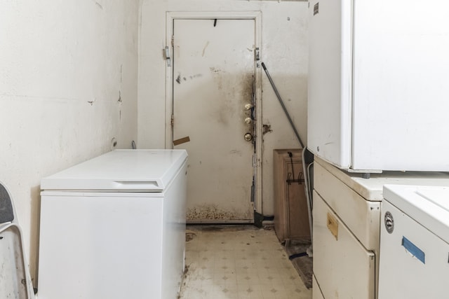 washroom with separate washer and dryer and light tile patterned floors